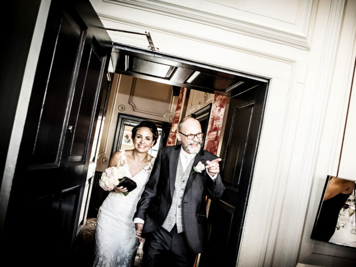 wedding-photography-of-the-bride-and-groom-entering-the-wedding-breakfast