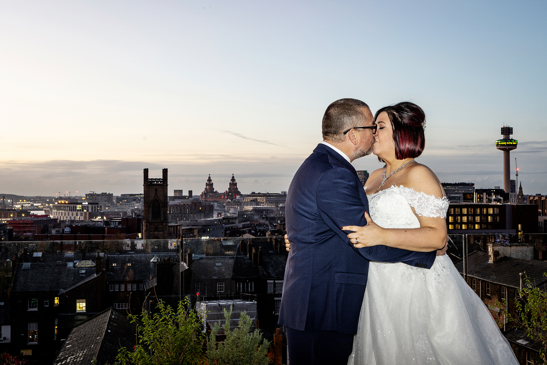 The bride and groom photographed at the Hope street hotel with the Liverpool city skyline