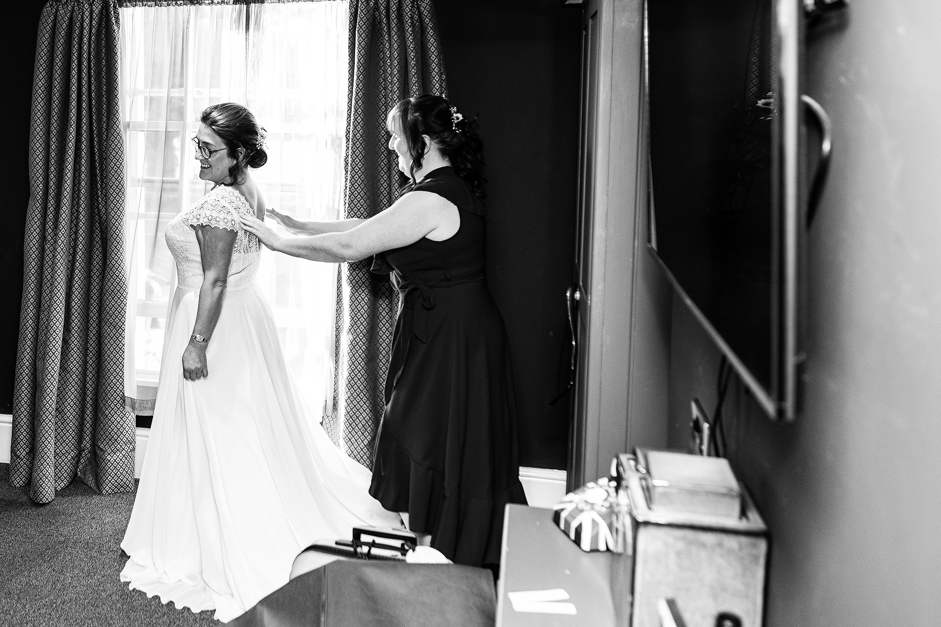 photography of the bride putting on her wedding dress